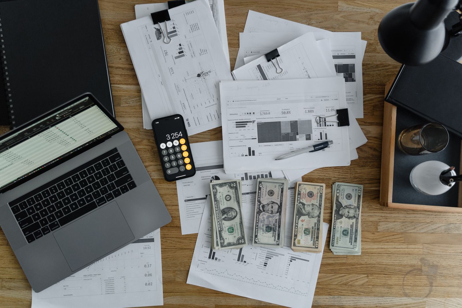Accountant desk with laptop, calculator, and financial reports