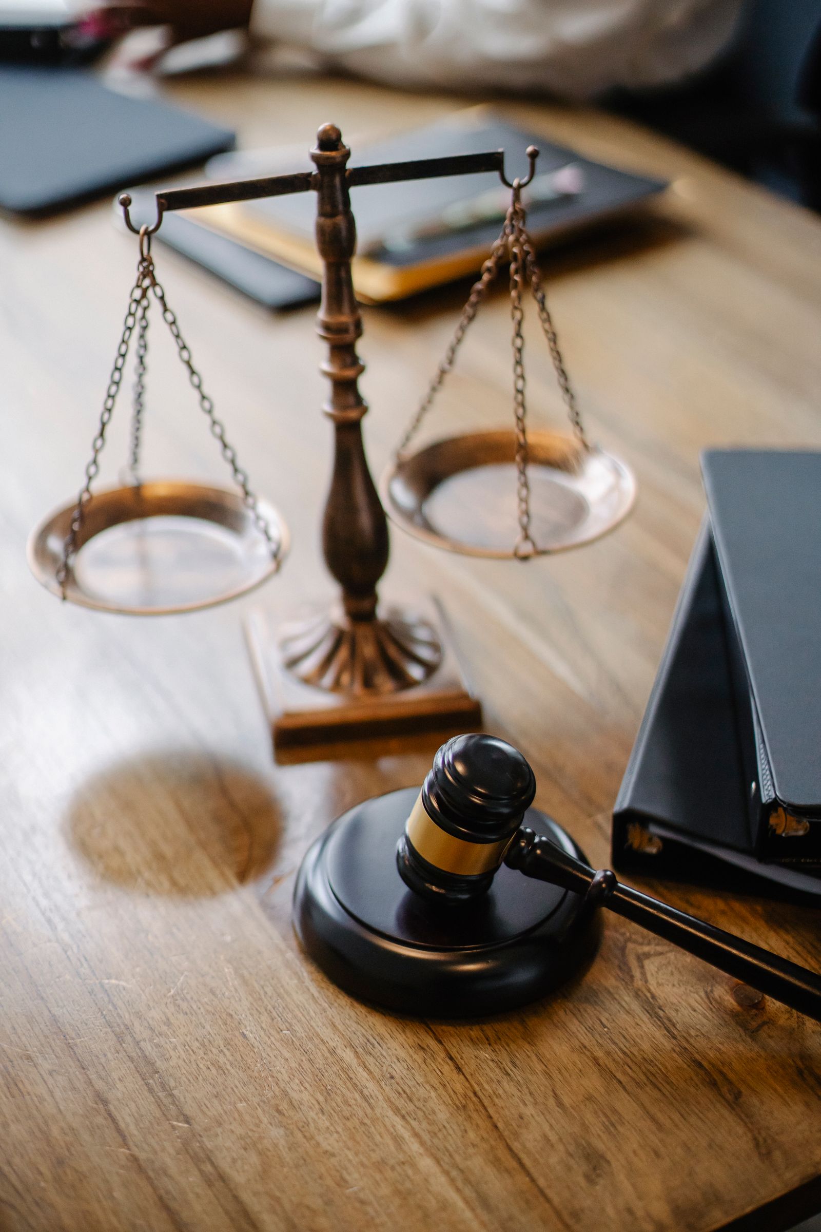 Law desk with scales of justice, gavel, and case binders